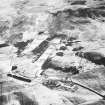 General oblique aerial view centred on the rifle range with the farmhouse and farmsteading and the remains of the fort, trenches, ring-ditch house and rig adjacent, taken from the SE.