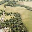 Oxenfoord Castle: oblique aerial view, taken from the NW, centred on cropmarks of a possible formal garden and linear cropmarks. Oxenfoord Castle is also visible in the left centre of the photograph.