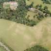 Oxenfoord Castle: oblique aerial view, taken from the NW, centred on cropmarks of a possible formal garden and linear cropmarks. Oxenfoord Castle and walled garden are also visible towards the top left hand corner of the photograph.