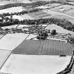 Oblique aerial view centred on the village with farmhouse adjacent, taken from the ESE.