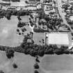 Oblique aerial view centred on the garden with the tower-house and school adjacent, taken from the E.