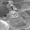 Oblique aerial view centred on the quarry with the farmhouse adjacent, taken from the NE.