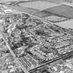Oblique aerial view of Broxburn centred on the town housing development designed by Wheeler and Sproson in 1968-70, and recorded as part of the Wheeler and Sproson Project.  Taken from the NW.