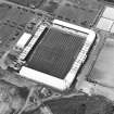 Oblique aerial view centred on the football stadium, taken from the SSE.