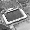 Oblique aerial view centred on the football stadium, taken from the ESE.