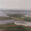 Oblique aerial view, from SE, centred on the island of Burray and Churchill Barrier No. 4, and showing Burray village in the left centre of the photograph.