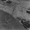 Oblique aerial view from SE.  Visible are two concrete hut bases at the NE end of the NE-SW main runway.