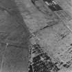 Oblique aerial view from NE.  Visible are two concrete hut bases at the NE end of the NE-SW main runway.