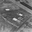 Oblique aerial view from NE.  Visible are the concrete bases for four hangars to the E of the main NE-SW runway.