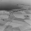 Oblique aerial view of the village of St Mary's and the remains of the military complex at Greaves, from N.