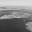Oblique aerial view of Burra Sound between Hoy and Graemsay, taken from the WNW.  Visible is the Second World War Skerry Coastal Battery and the blockship, 'Inverlane', formerly a tanker.