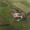 Oblique aerial view from SW.  Some of the hangar support blocks for the airship sheds are visible. In the centre of the photograph are the surviving remains of the World War Two vehicle repair sheds and the concrete bases of several other ancillary buildings.