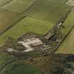 Oblique aerial view from SE.  Some of the hangar support blocks for the airship sheds are visible. In the centre of the photograph are the surviving remains of the World War Two vehicle repair sheds and the concrete bases of several other ancillary buildings.