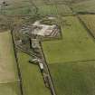 Oblique aerial view from N.  Some of the hangar support blocks for the airship sheds are visible. In the centre of the photograph are the surviving remains of the World War Two vehicle repair sheds and the concrete bases of several other ancillary buildings.