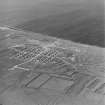 Oblique aerial view  of Orkney, Flotta, Golta, of the 'Z' battery of unrotating fixed projectile launchers with ammunition huts.  The concrete hut bases of the acommodation camp and the concrete bases of several other structures are also visible. Taken from the SE.