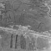 Oblique aerial view showing hut bases which formed the accommodation camp for the gun batteries.