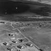 Oblique aerial view of Orkney, Hoy, Lyness, Royal Naval Oil terminal, the NAAFI building, generating house and a series of air raid shelters.