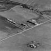 Oblique aerial view of Orkney, Hoy, Lyness, Royal Naval Oil terminal, view from NW of E part of the accommodation camp, ancillary buildings to the E of the road.