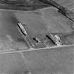 Oblique aerial view of Orkney, Hoy, Lyness, Royal Naval Oil terminal, view from WNW, of E part of the accommodation camp, ancillary buildings to the E of the road.