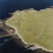 Oblique aerial view of Orkney, Rerwick Head, Rerwick Battery, taken from the W.  Visible are the gun-emplacements, battery observation tower, searchlight platforms, concrete hut bases for the accommodation camp and two air-raid shelters cut into the shore..