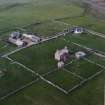 Oblique aerial view centred on the house, farmstead and cottage taken from the SW