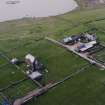 Oblique aerial view centred on the house, farmstead and cottage taken from the SE