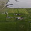 Oblique aerial view centred on the house, farmstead and cottage taken from the N