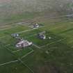 Oblique aerial view centred on the house, farmstead and cottage taken from the NW