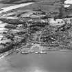 Oblique aerial view of Rothesay, taken from the N, centred on the town.  A harbour is visible in the bottom half of the photograph.  A castle and the Winter Gardens are visible, in the centre of the photograph.