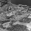 Oblique aerial view of Rothesay, taken from the S, centred on the town.  A harbour is visible in top right-hand side of the photograph.  A castle and the Winter Gardens are visible in the top centre of the photograph.