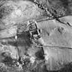 Oblique aerial view centred on the farmstead with the remains of the cairn adjacent, taken from the NW.