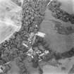 Oblique aerial view centred on the church, churchyard and hotel, taken from the SE.