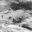 Oblique aerial view centred on the farmhouse and farmstead with the remains of the township adjacent, taken from the N.