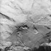 Oblique aerial view centred on the farmhouse and farmstead with the remains of the township adjacent, taken from the SW.