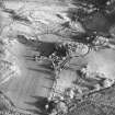 Oblique aerial view centred on the farmhouse, byre, farmsteading and the remains of the earthwork and farmstead, taken from the WNW.