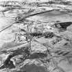 Oblique aerial view centred on the remains of the coal mines, taken from the SE.