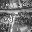 Oblique aerial view of Cumbernauld centred on Kildrum Parish Church, taken from the SW and recorded as part of the World of Worship project.