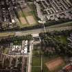 Oblique aerial view of Cumbernauld centred on Kildrum Parish Church, taken from the NE and recorded as part of the World of Worship project.