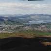 General oblique aerial view looking across Alexandria towards Loch Lomond and mountains beyond, taken from the E.