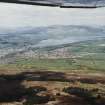 General oblique aerial view looking across Alexandria towards Loch Lomond and mountains beyond, taken from the E.