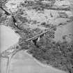 Oblique aerial view centred on the railway viaduct with road bridge adjacent, taken from the S.