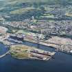 General oblique aerial view looking across the docks towards Greenock, taken from the N.