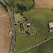 Oblique aerial view centred on the remains of the abbey and the doocot and cottage, taken from the W.