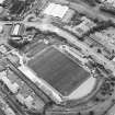 Oblique aerial view centred on the football stadium, taken from the NW.