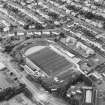 Oblique aerial view centred on the football stadium, taken from the SE.