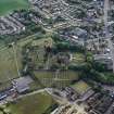 Oblique aerial view of Lennoxtown centred on the remains of the church and cemetery, taken from the NW.