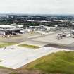 Oblique aerial view centred on the airport with the road bridge adjacent, taken from the NW.