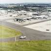 Oblique aerial view centred on the airport with the road bridge adjacent, taken from the NW.