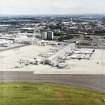 Oblique aerial view centred on the airport with the road bridge adjacent, taken from the NW.