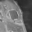 Oblique aerial view centred on the football ground with the school adjacent, taken from the W.